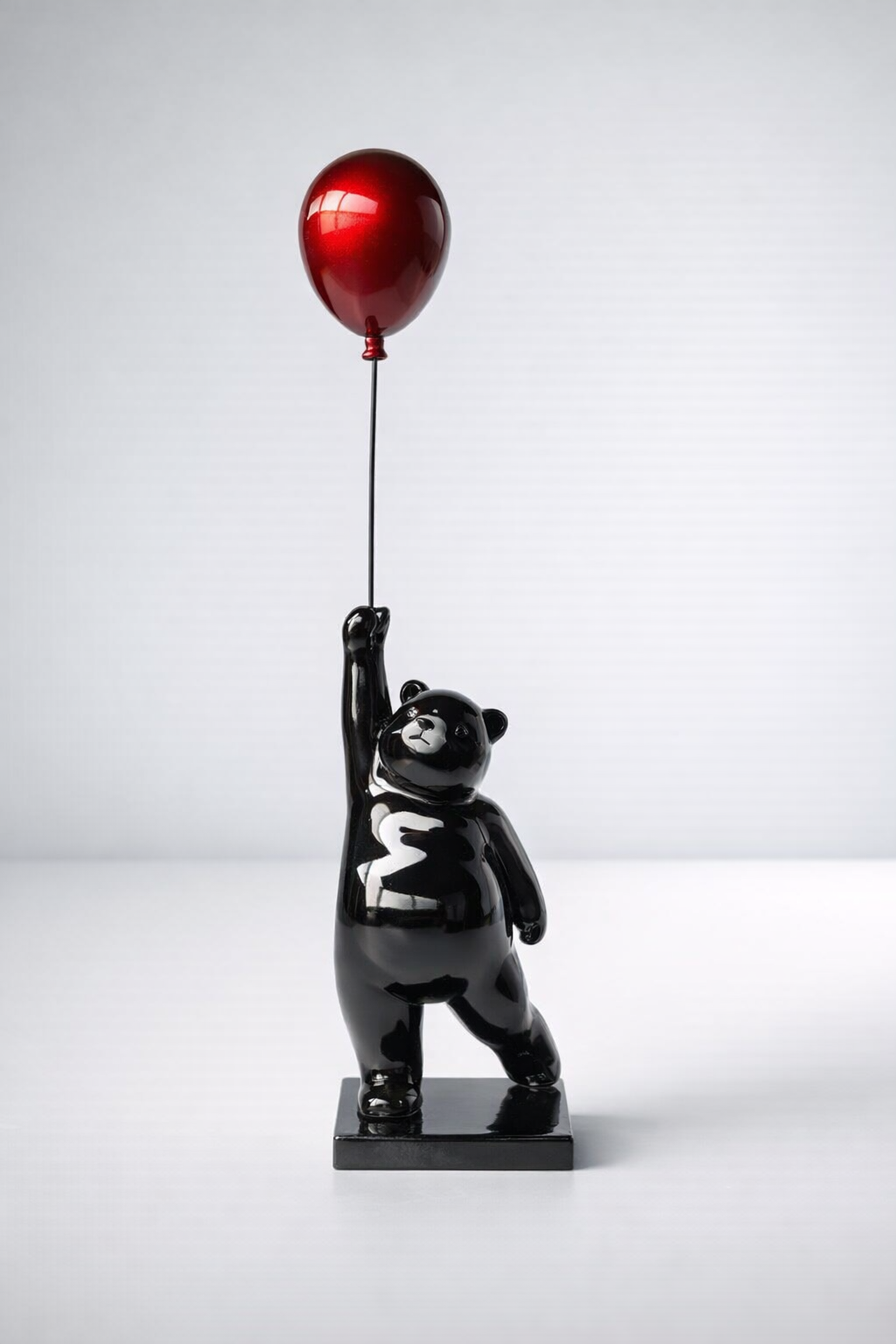 Large Black Bear Holding Red Balloon